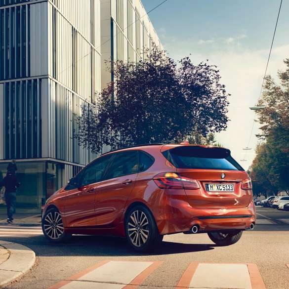 Driving dynamics BMW 2 Series Active Tourer Driving dynamics BMW 2 Series Active Tourer 220i F45 Sunset Orange metallic three-quarter rear view
