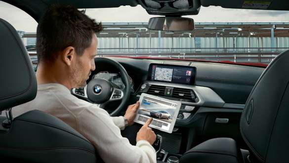 WiFi hotspot BMW X4 WiFi hotspot BMW X4 G02 2018 man using tablet in his BMW