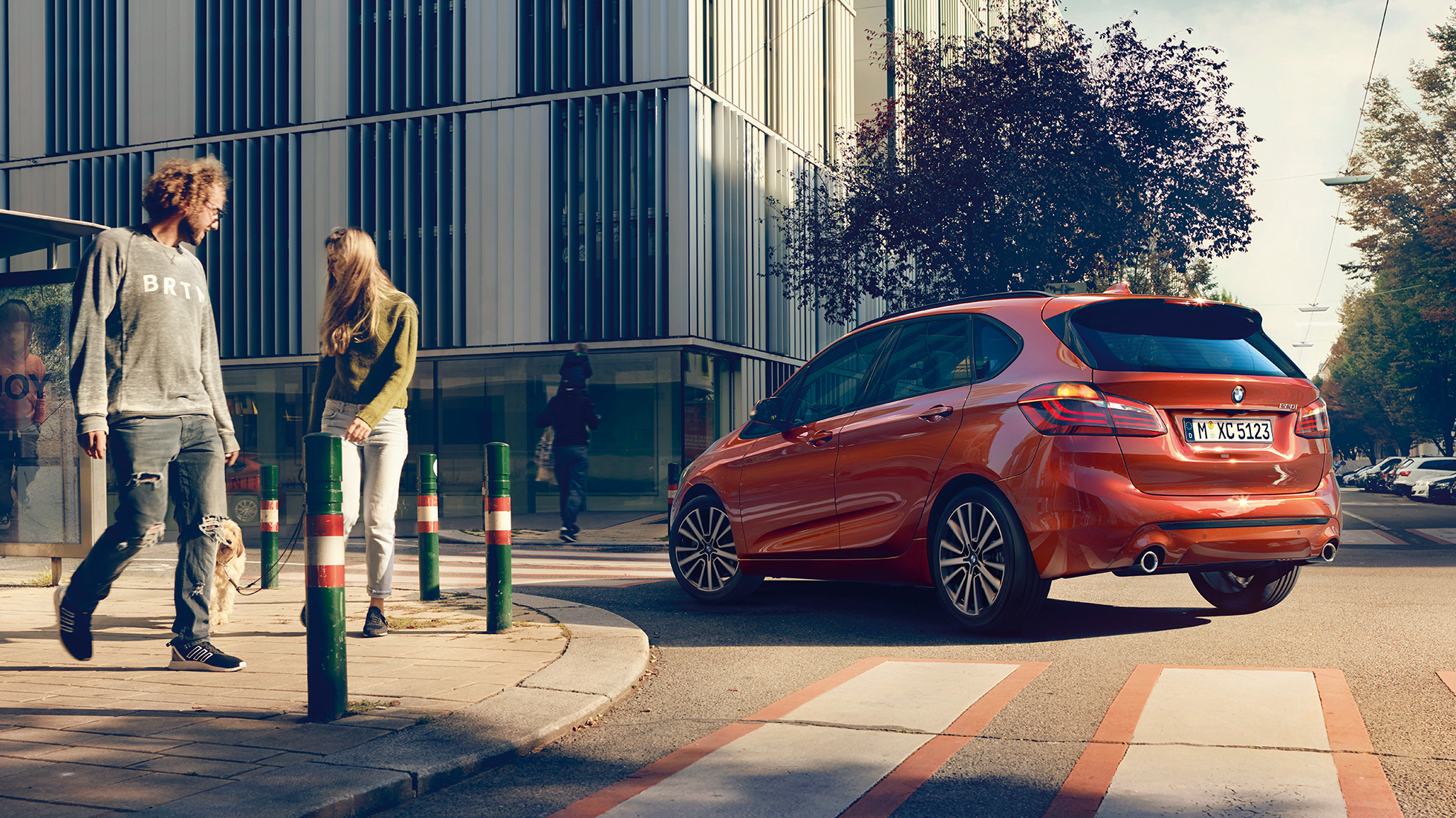 Driving dynamics BMW 2 Series Active Tourer Driving dynamics BMW 2 Series Active Tourer 220i F45 Sunset Orange metallic three-quarter rear view