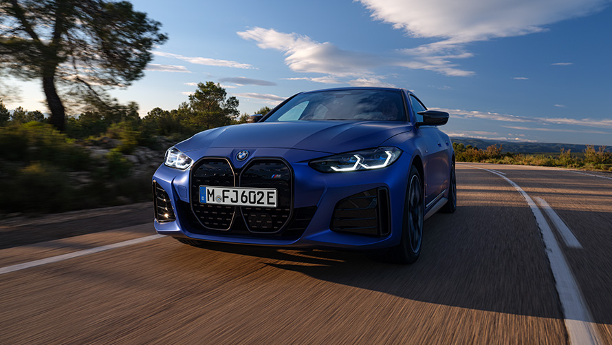 BMW i4 M50 G26 2021 BMW Individual Frozen Portimao Blue metallic front view driving BMW i4 M50 G26 2021 BMW Individual Frozen Portimao Blue metallic front view driving