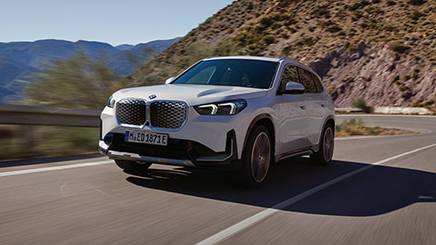 BMW X Series BMW iX1 U11 side view driving on the road