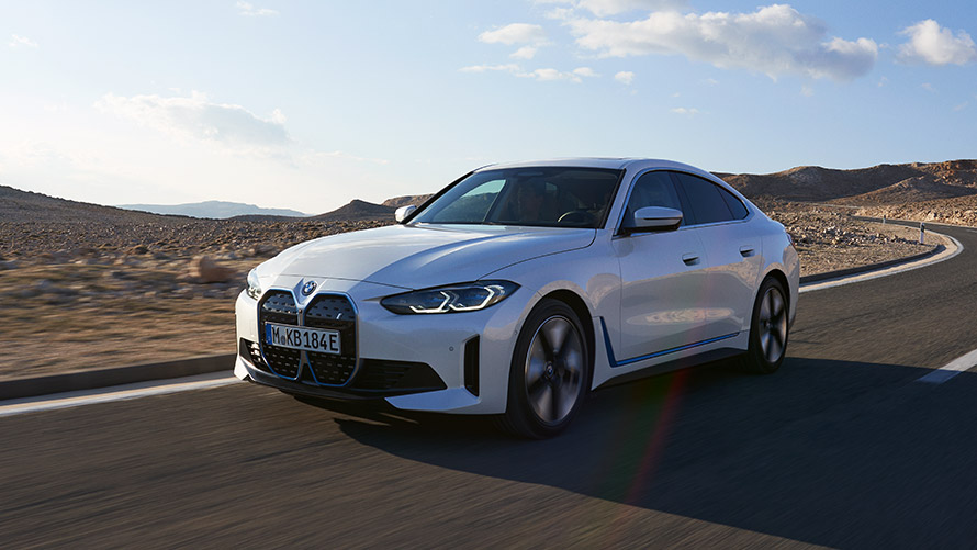 BMW i4 G26 first generation three-quarter front view driving BMW i Series BMW i4 G26 first generation three-quarter front view driving