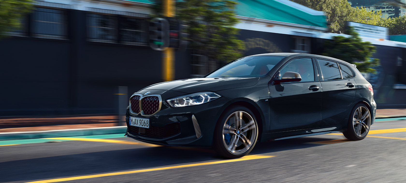 BMW 1 Series M135i xDrive (F40) BMW 1 Series M135i xDrive (F40) in Black Sapphire metallic Driving car in urban environment
