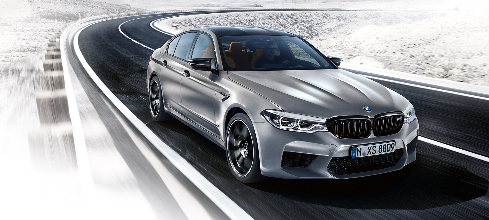 Design-Highlights. BMW M5 Competition driving shot three-quarter front.