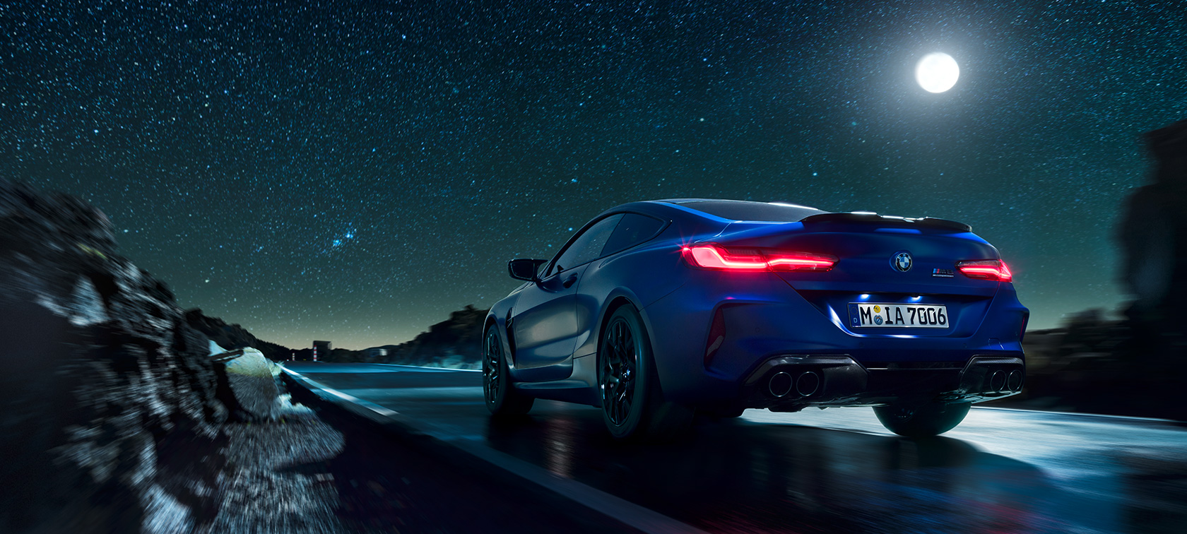 BMW M8 Competition Coupé, front view. BMW M8 Competition Coupé, front view, driving at night with full moon.