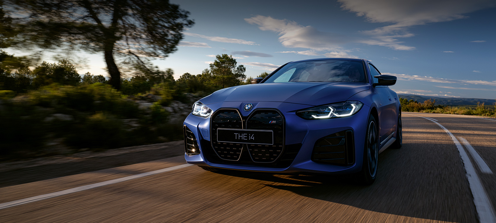 BMW i Series BMW i4 M50 three-quarter front view driving on the street