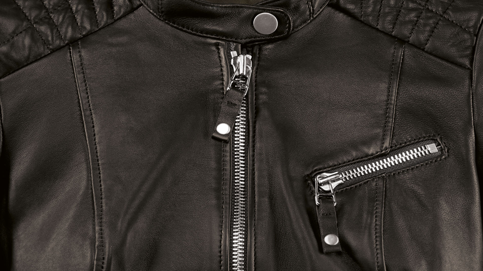 BMW Ladies Leather Jacket. The picture shows a close-up of the zip fastener of the BMW Ladies Leather Jacket in black.