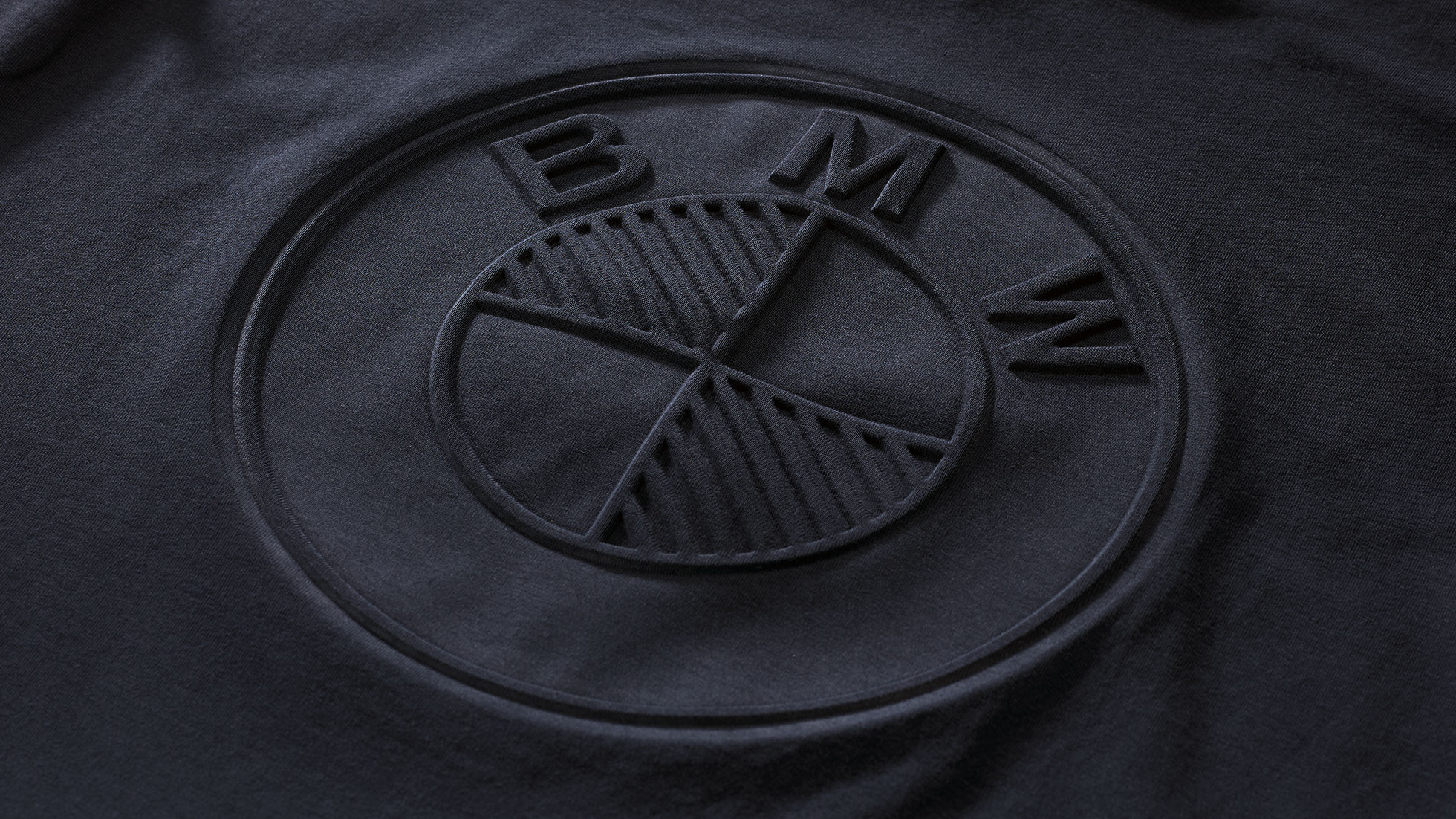 BMW T-shirt, ladies. The photo is a close-up view of the logo on the BMW T-shirt, ladies.