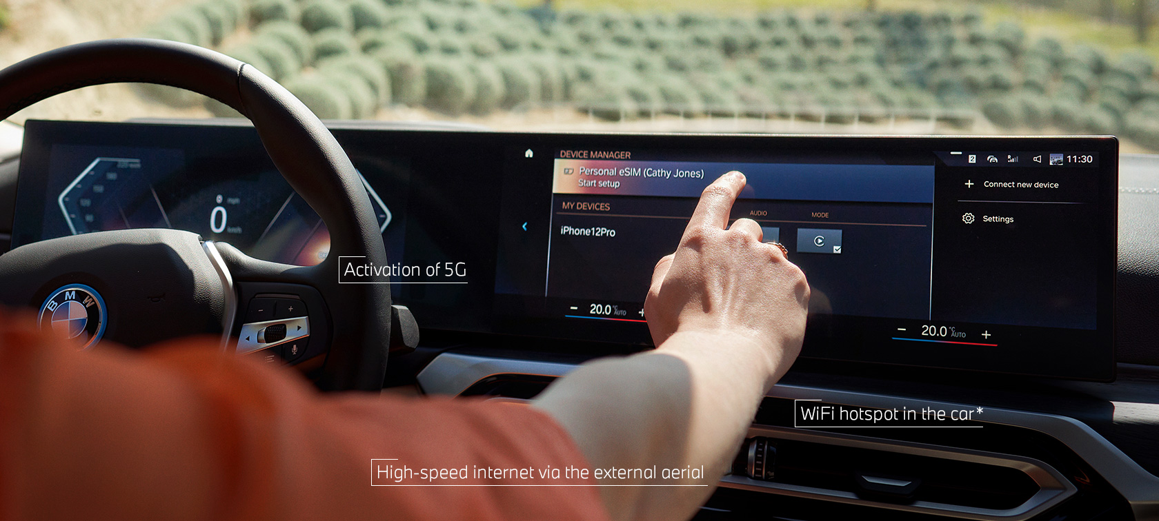 Person using Personal eSIM in the Control Display of the BMW iX via touch control Person using Personal eSIM in the Control Display of the BMW iX via touch control