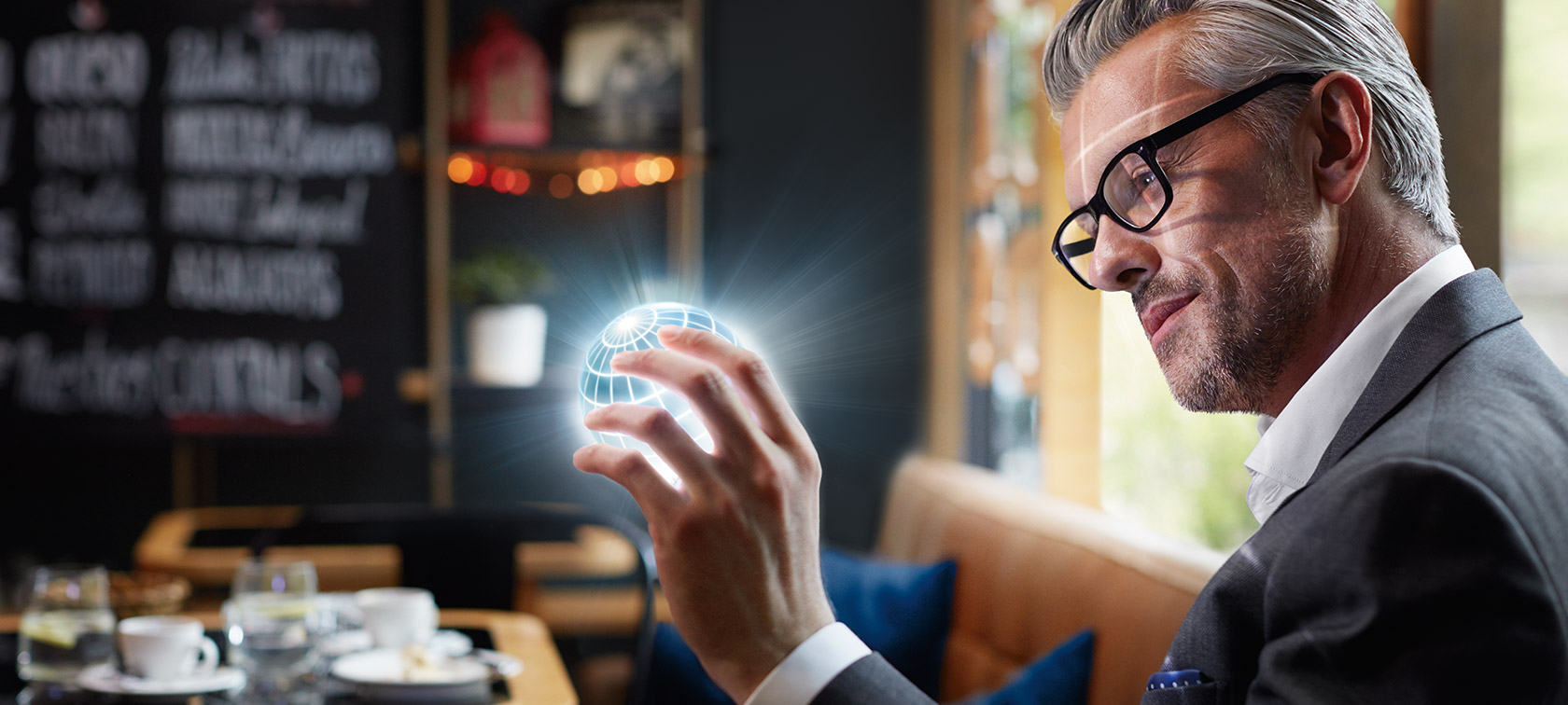 BMW ConnectedDrive Digital Services Man holds ConnectedDrive globe in his hands and is fascinated.