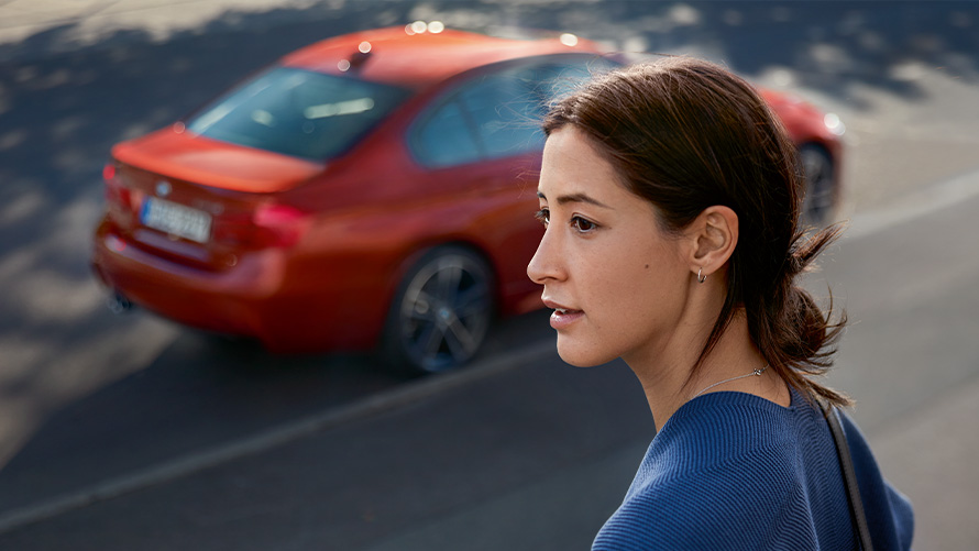 BMW Roadside Assistance Woman in side profile in front of BMW
